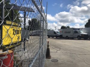 An electric fence with a warning sign on it