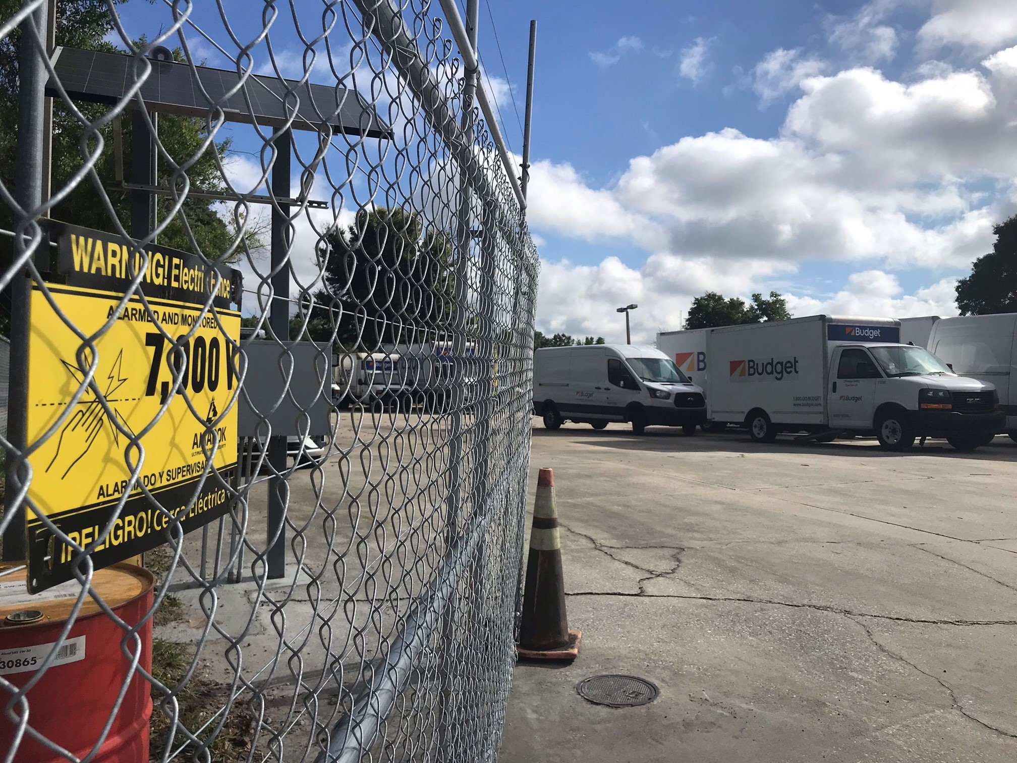 An electric fence with a warning sign on it