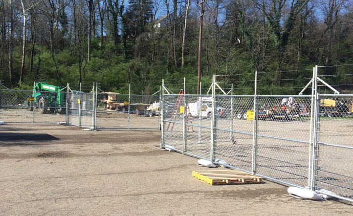 An electric portable fence is surrounding a construction site