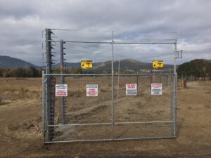 An electric fence gate at a cannabis farm