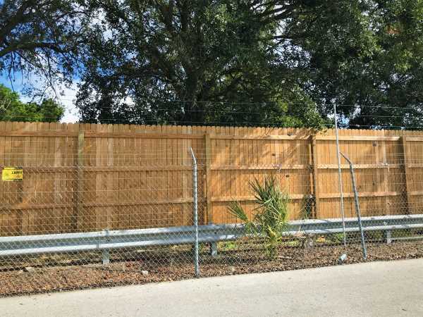 fence-and-wood-panels with electric guard dog fence layered