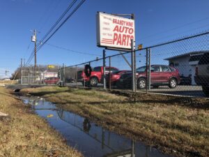 Cars at Brandywine Auto Parts surrounded by an electric fence