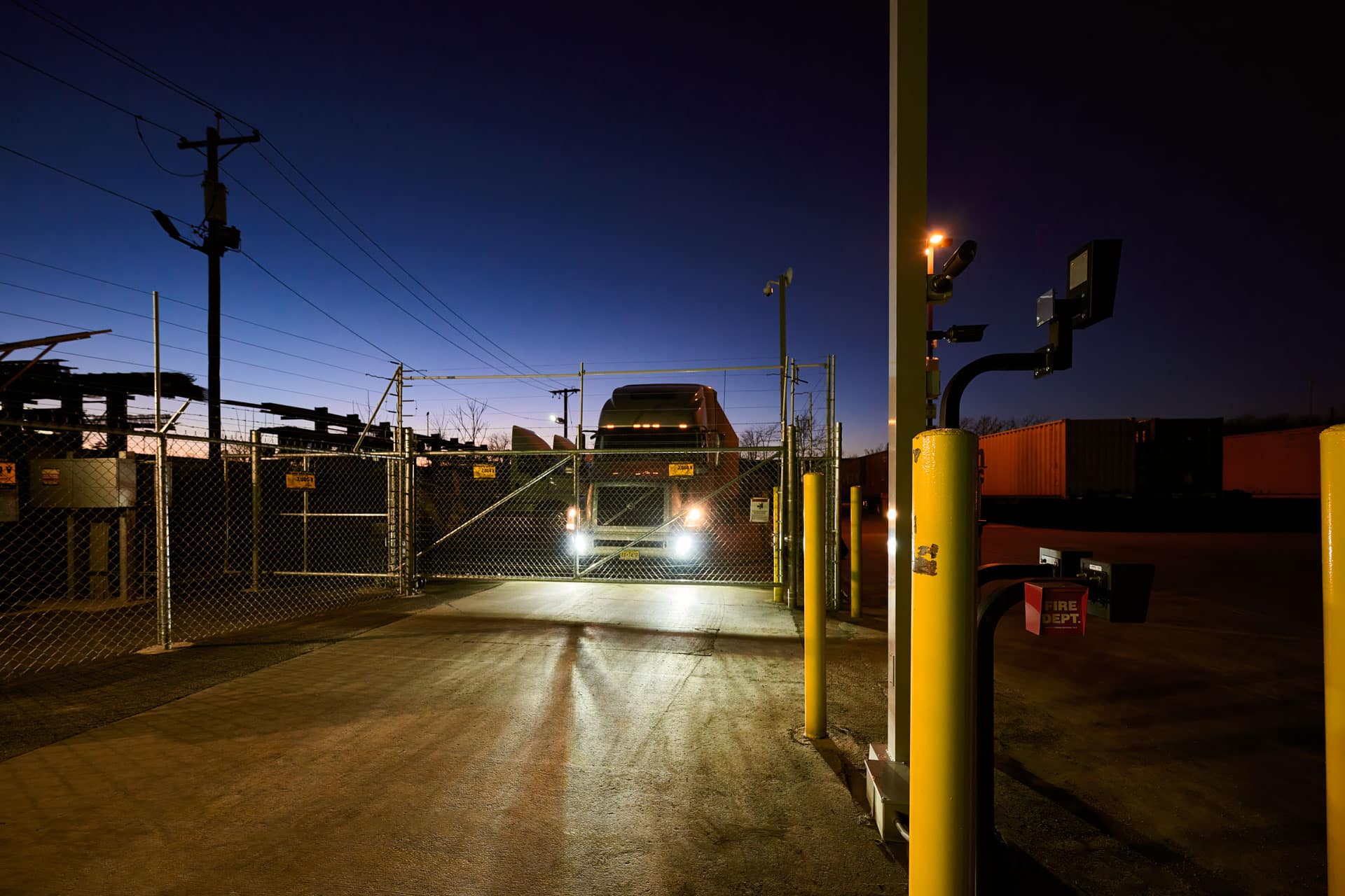 A Truck is Driving Through a Gate at Night