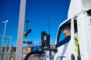 a man is driving a stg logistics truck
