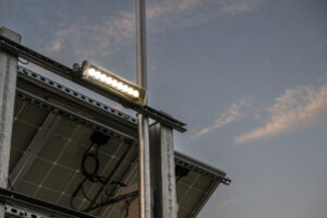A Building With Solar Panels and a Light on Top of It