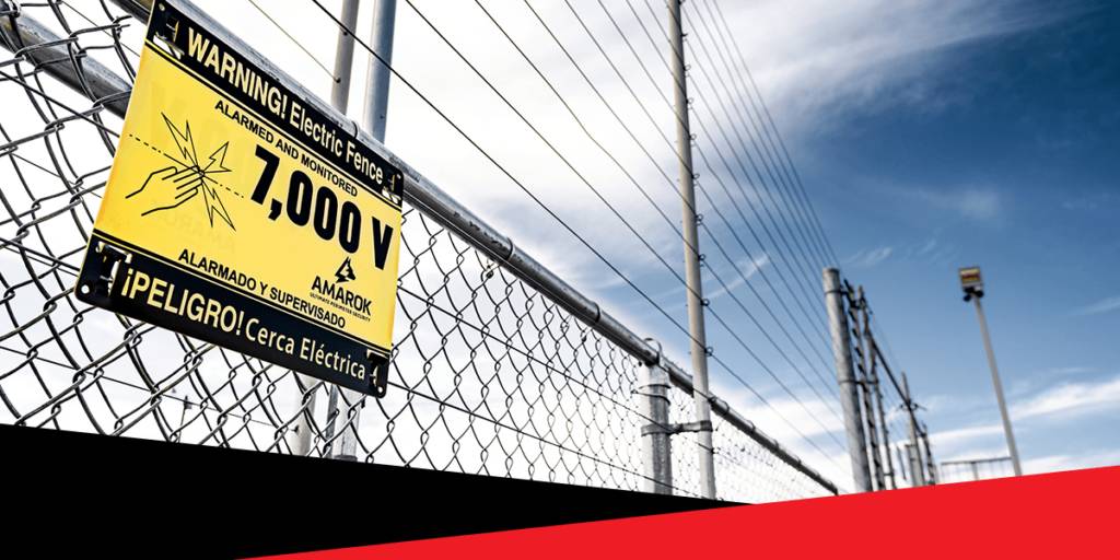 A Sign on a Chain Link Fence Says Warning Electric Fence