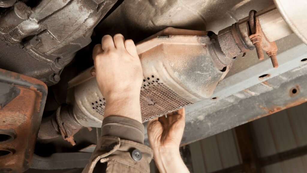 a person is working on the underside of a car