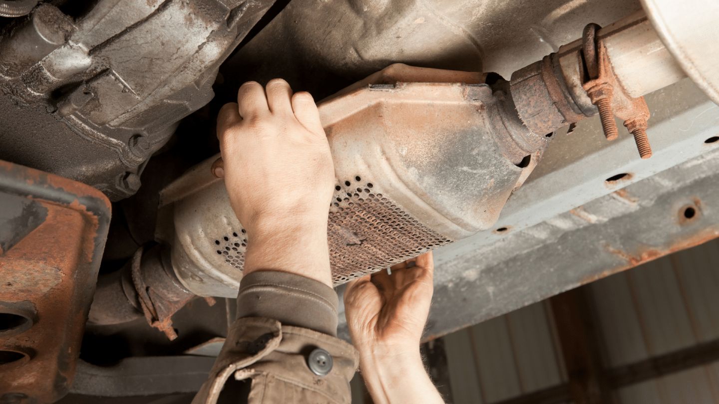 a person is working on the underside of a car